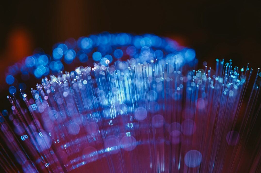 Fibre optic cables with glowing blue light representing content distribution network