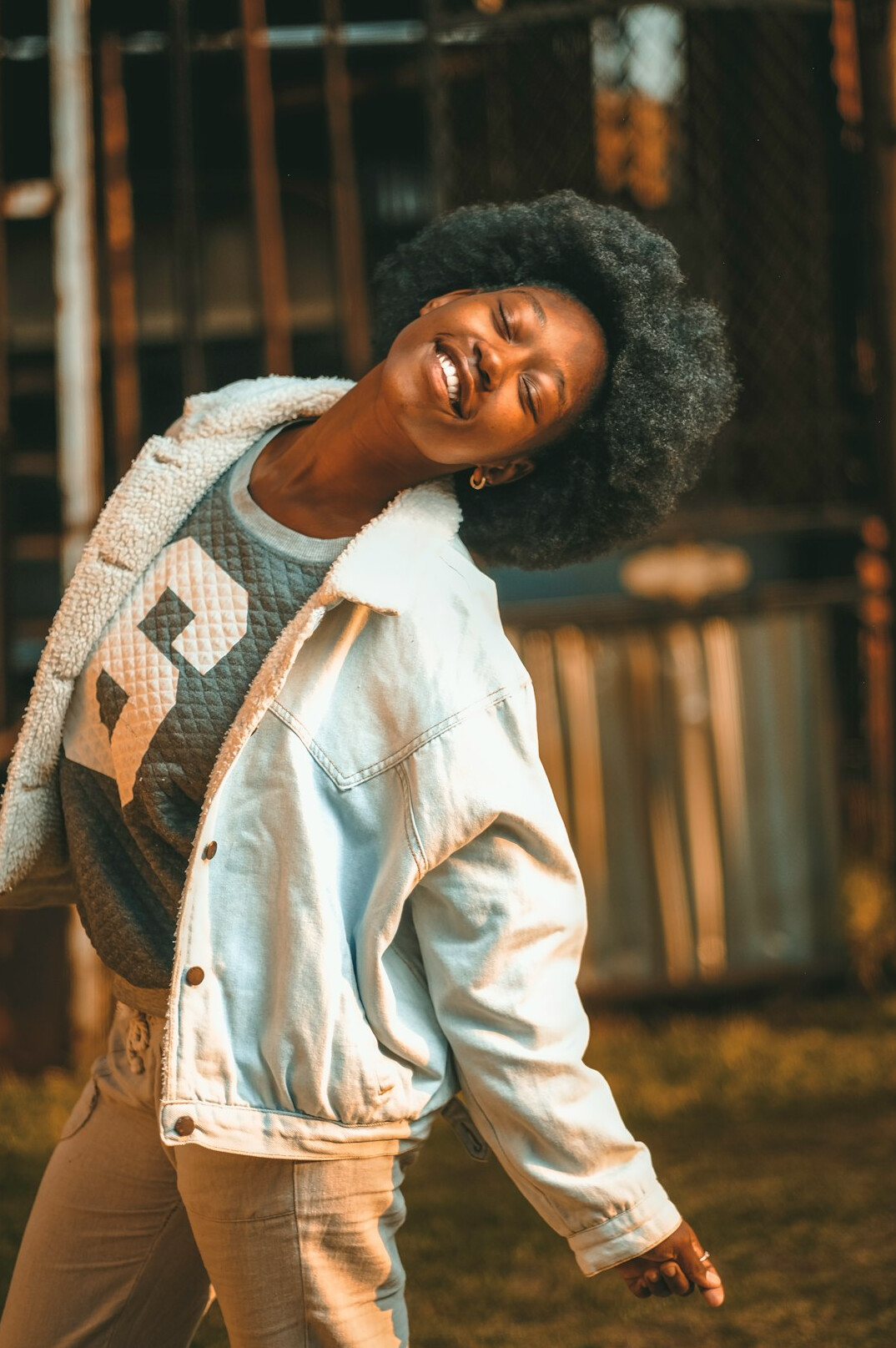 Portrait of a smiling Black woman with natural hair wearing a casual blazer